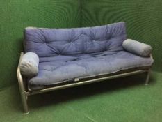 A contemporary metal framed folding bed settee