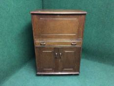 An Ercol oak cocktail cabinet