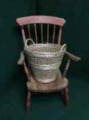 A pine armchair and a log basket