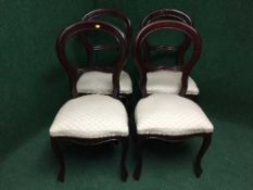 A set of four reproduction mahogany balloon backed chairs