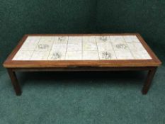 A 1970's teak tiled topped coffee table