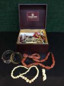 A box of beaded and costume jewellery - necklaces, brooches,