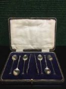 A set of six cased silver teaspoons and a pair of sugar tongs