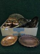 A box of brass and copper wall plaques, bellows, copper measuring jugs, kitchen storage jars,