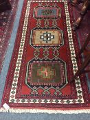 A fringed Persian rug with medallion design