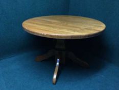 An oak pedestal dining table