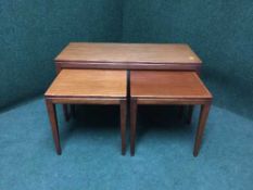 A nest of three mid twentieth century teak tables