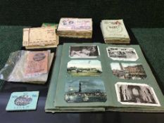 An early 20th century postcard/photograph album,