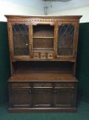 A Jaycee Oak leaded glass door dresser