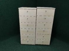 A pair of beech six drawer chests