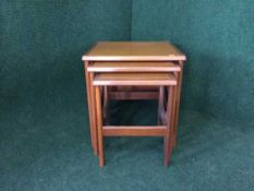 A nest of three mid 20th century teak tables