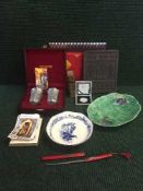 A tray of boxed commemorative silver Panda coin, postcards, oriental tea brick,