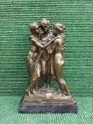 A bronze figure on marble base - three graces