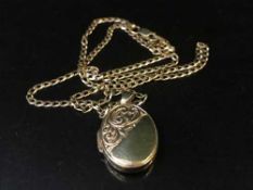 A gold locket on chain stamped 375, 5.