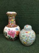 A hand painted oriental style vase and a lidded temple jar