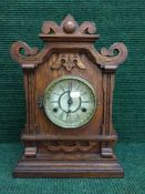 An Edwardian oak eight day mantel clock