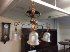 An Arts and Crafts copper light fitting in the style of W A S Benson
