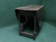 A late 19th century oak gate leg table fitted a drawer