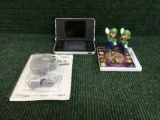 A Nintendo DS XL with charger and game