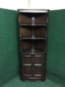 An Ercol corner cabinet