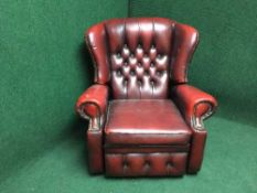 A red buttoned leather chesterfield reclining chair