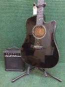 A Fender semi acoustic guitar on stand together with a B.