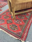 A fringed Persian carpet with medallion design