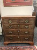 An antique mahogany chest of five drawers on bracket feet