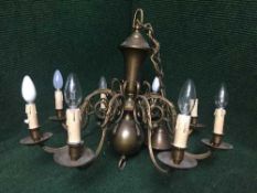 A brass eight way light fitting