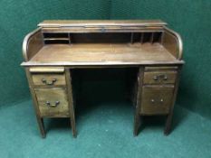 A late Victorian mahogany roll topped desk