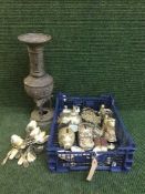 An antique bronzed embossed vase and a basket of plated cutlery,