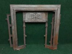 An antique cast iron fire insert