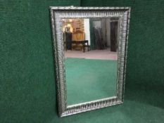 A contemporary silvered framed mirror