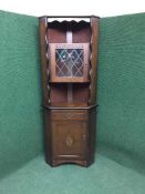An oak leaded glass door corner cabinet