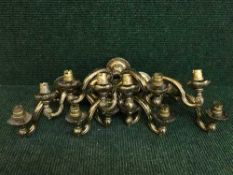 A set of six twin branch brass wall lights.
