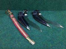 Two Kukri knives and a Eastern style sword with brass hand guard in scabbard