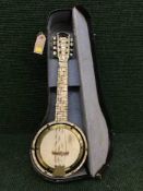 A cased Savannah miniature banjo