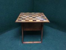 A storage table with chess board top containing chess pieces