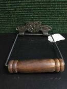 A reproduction metal Victorian toilet roll holder