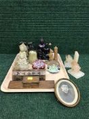 A tray of glass paperweights, three wooden monkeys,