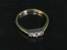An 18ct gold three stone diamond ring