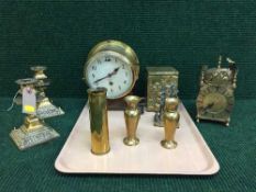 A circular brass Smiths clock, pair of candlesticks, tea caddy, carriage clock,