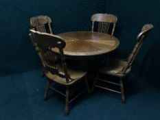 An oak effect kitchen table and four high backed chairs