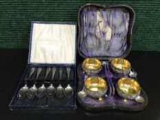 A set of four cased Elkington salts, with four salt spoons.