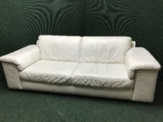 A cream leather three seater settee