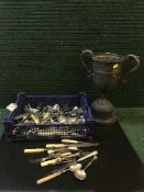 A basket of plated flatware,