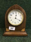 An inlaid mahogany arched topped mantel clock
