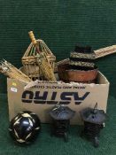 A box and basket of metal tea light holders, oriental resin figures, oriental parasols,