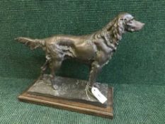 A bronze figure on a wooden base of a setter