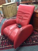 A red leather reclining electric armchair by De Sede